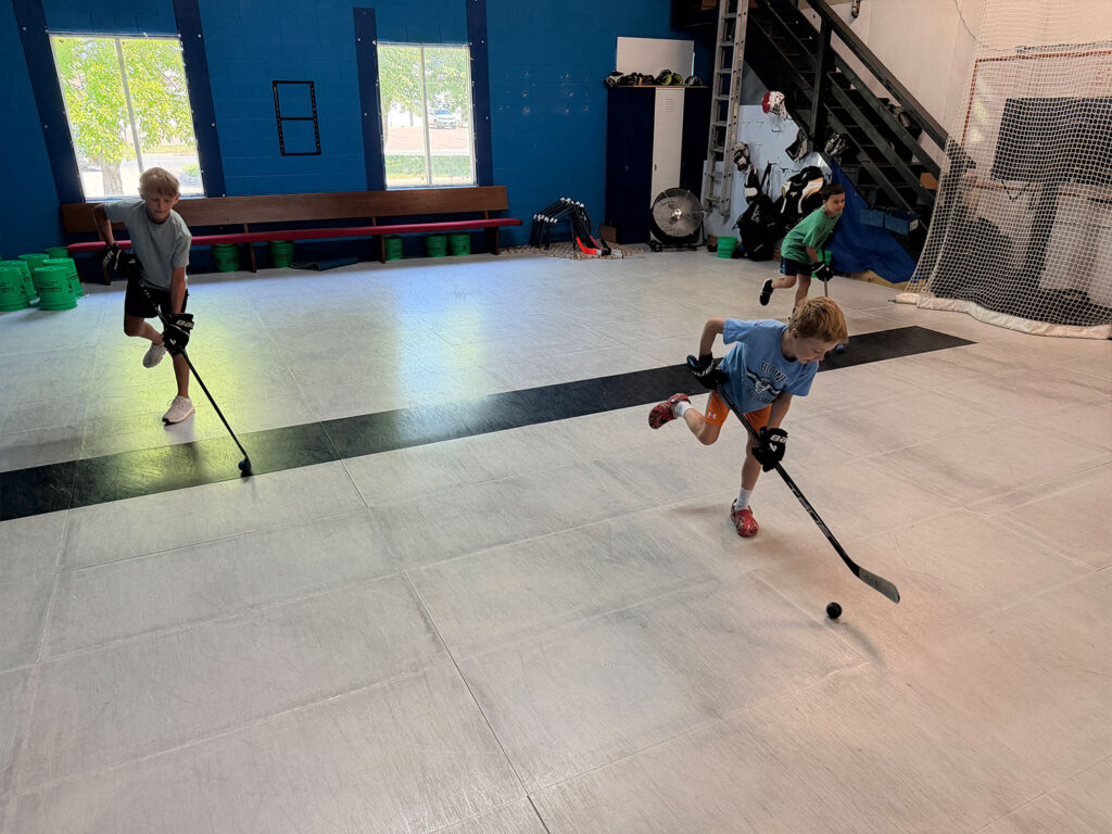 Dryland training area at Build Your Game with synthetic ice and blue boards